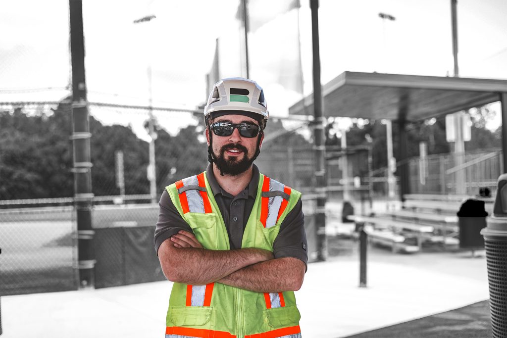 Branch Male Employee with Hands Crossed Smiling On Jobsite
